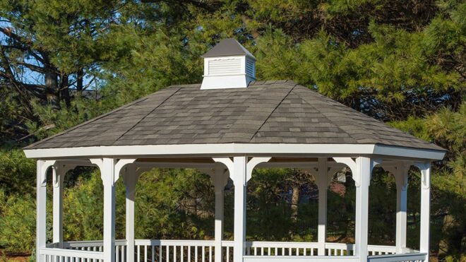 White vinyl, oval shaped, gazebo with a cupola.