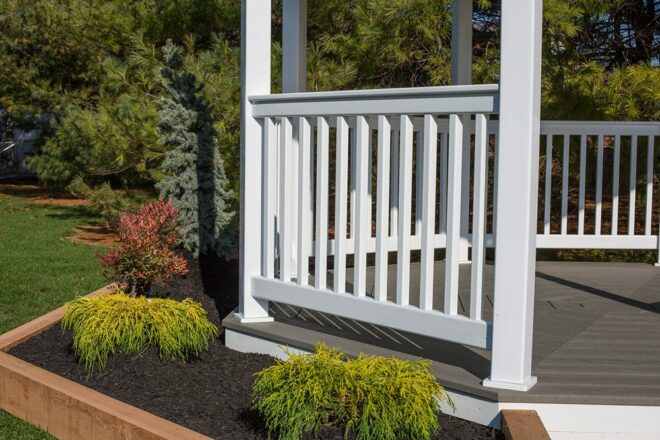 White vinyl gazebo railing, affixed to a composite floor.