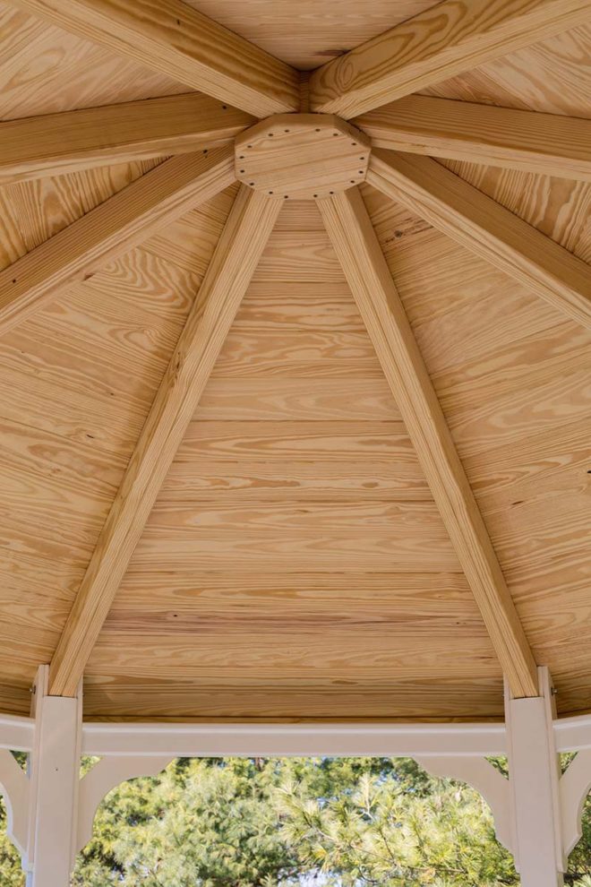 Wooden inner roof of a white vinyl gazebo.
