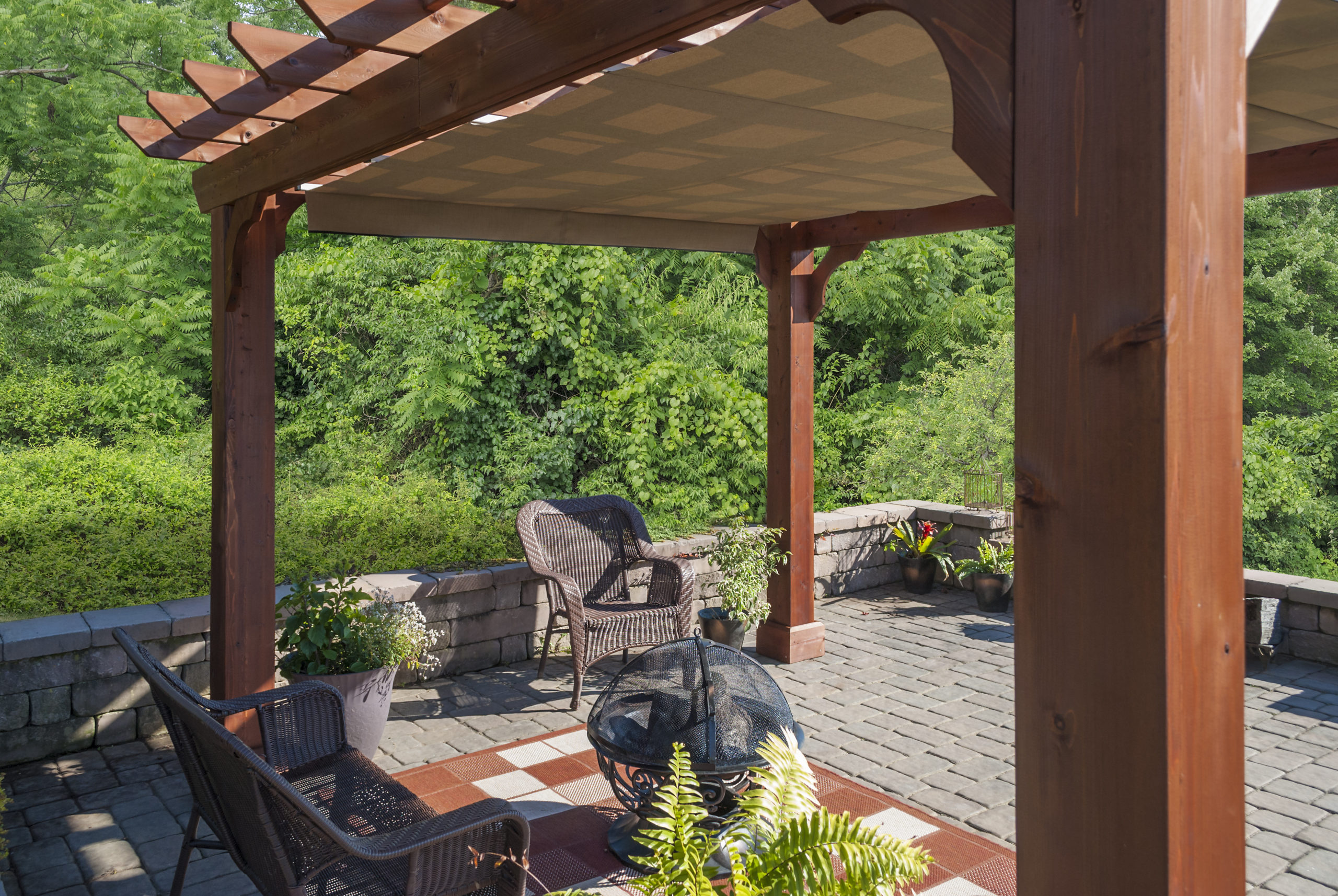 Wooden pergola with an EZShade canopy.