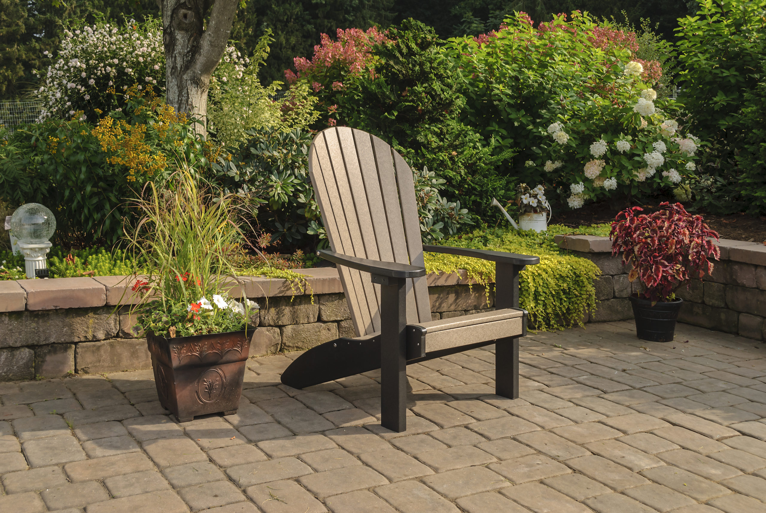 Backyard patio and black & brown poly Adirondack chair.