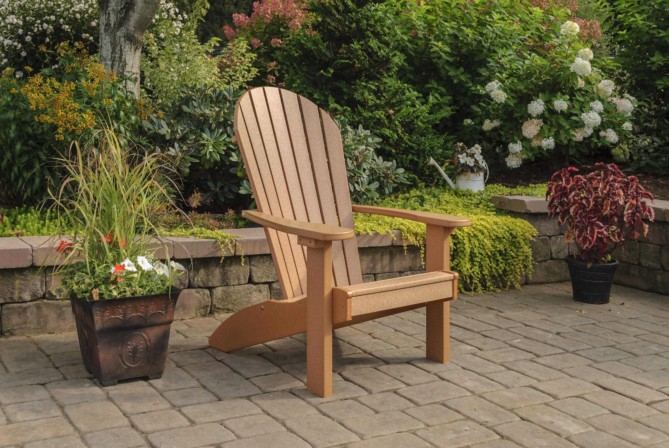 Backyard patio with light brown poly Adirondack chair.