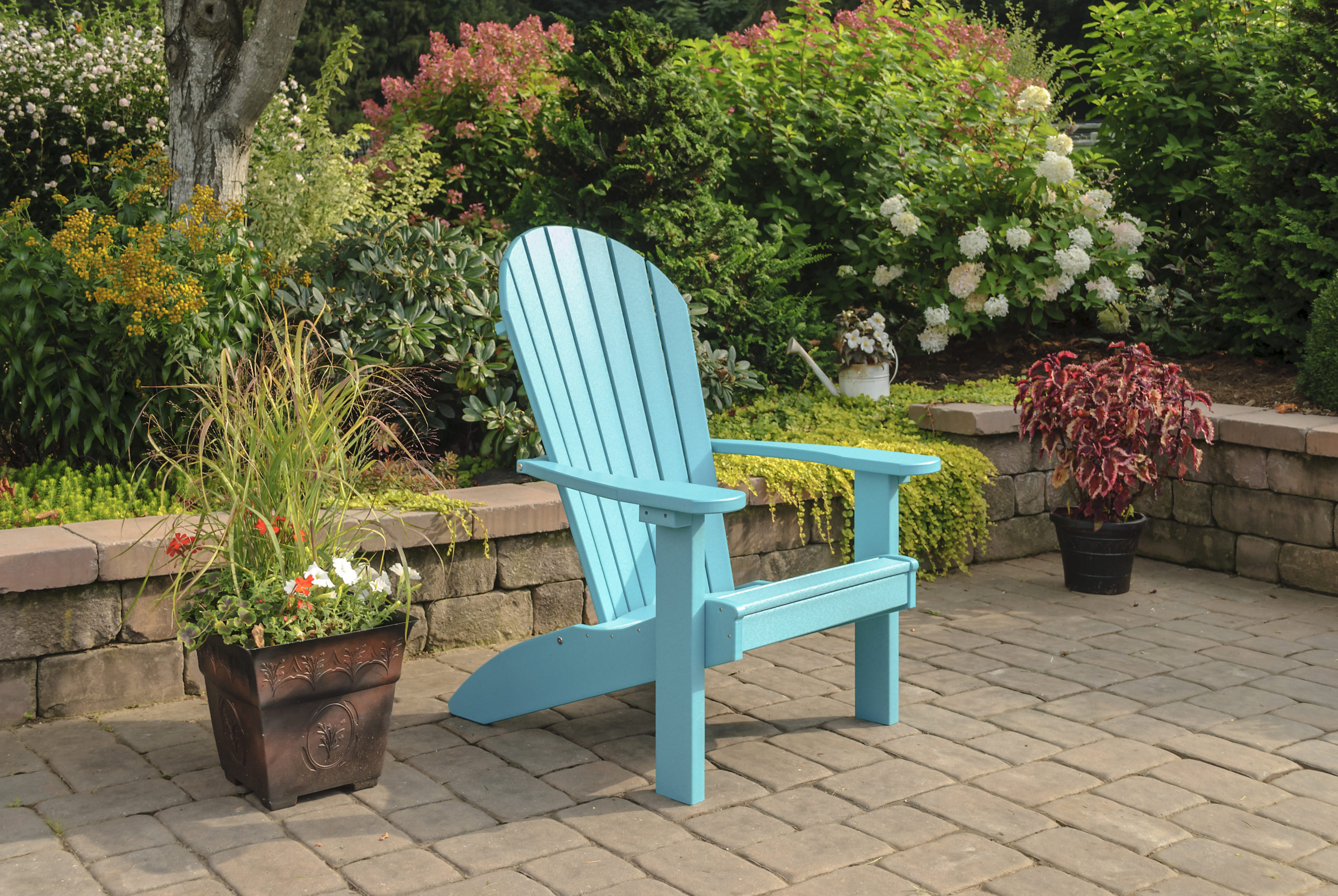 Backyard patio and bright blue poly Adirondack chair.