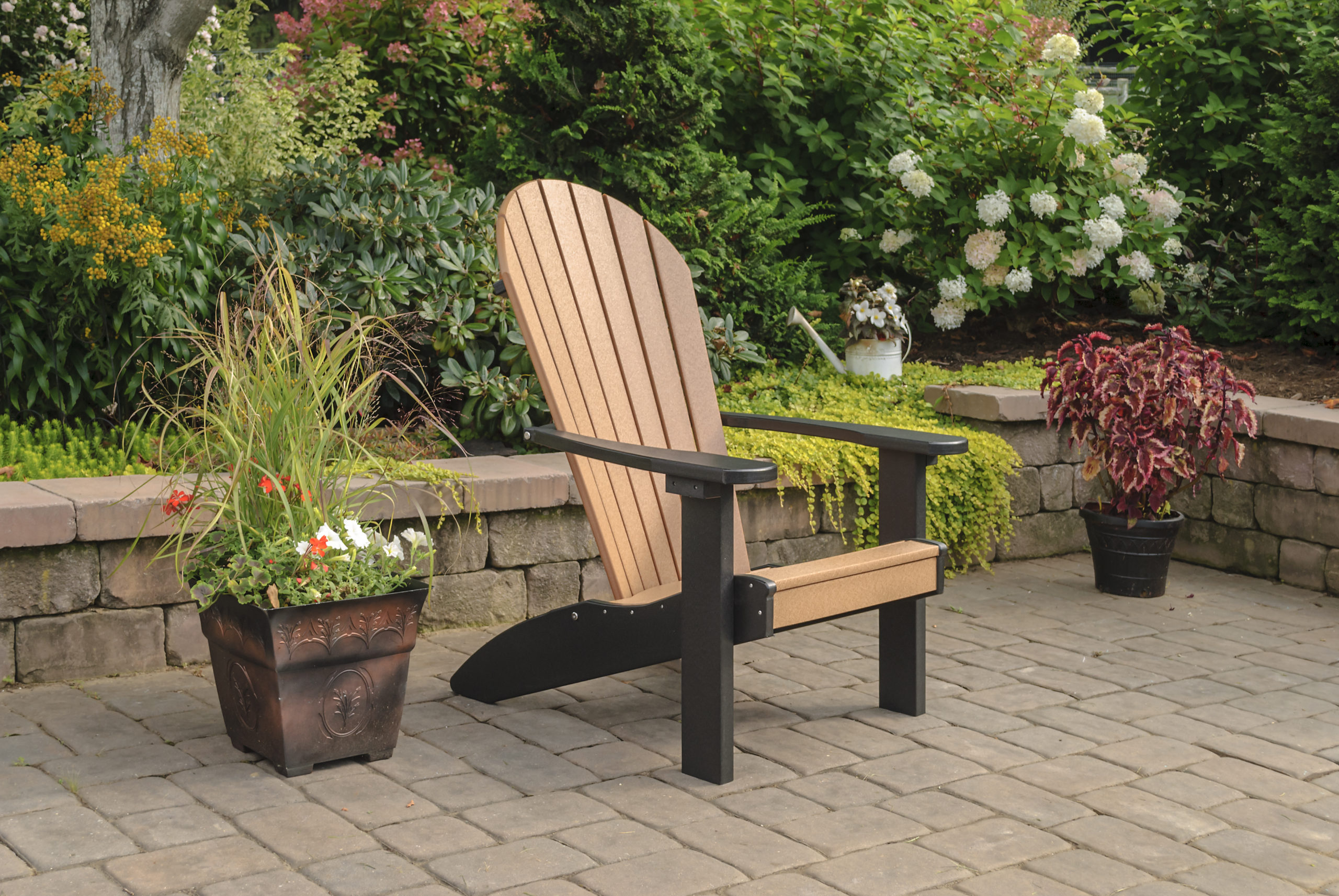 Backyard patio and black & brown poly Adirondack chair.