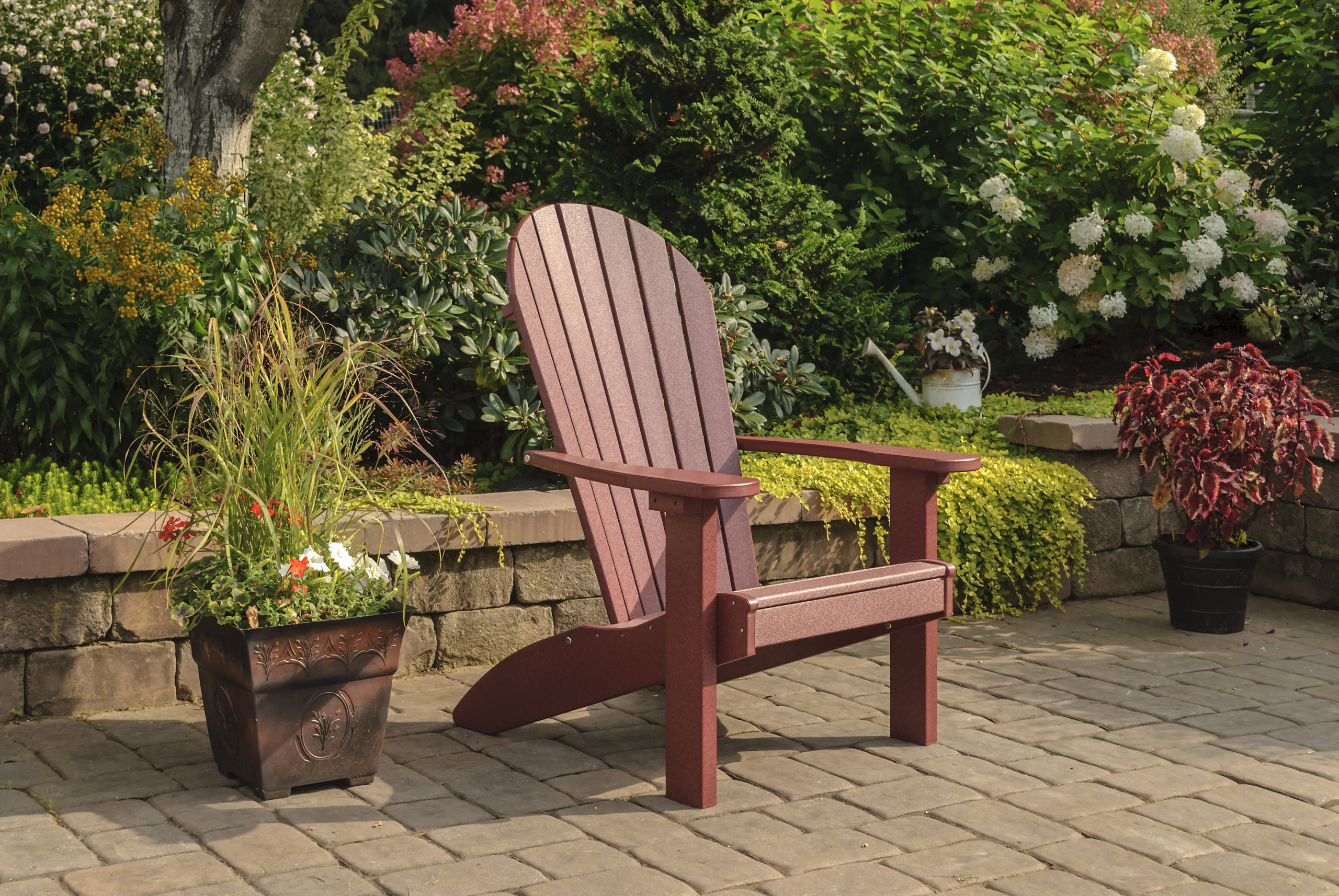 Backyard patio and maroon poly Adirondack chair.