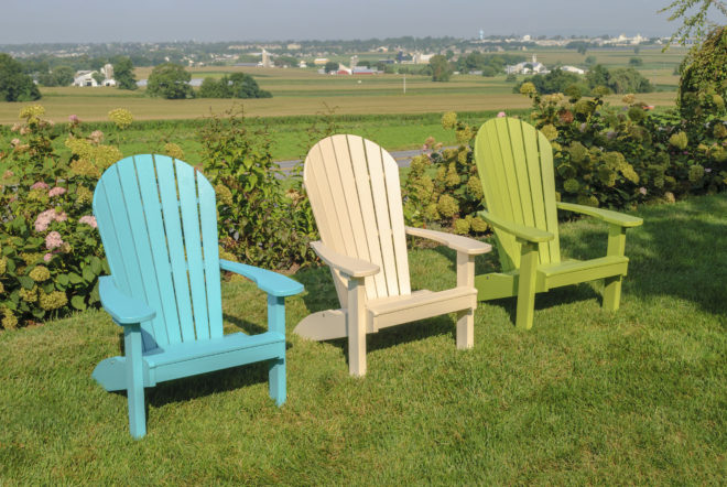 Blue, natural, and green poly Adirondack chairs.