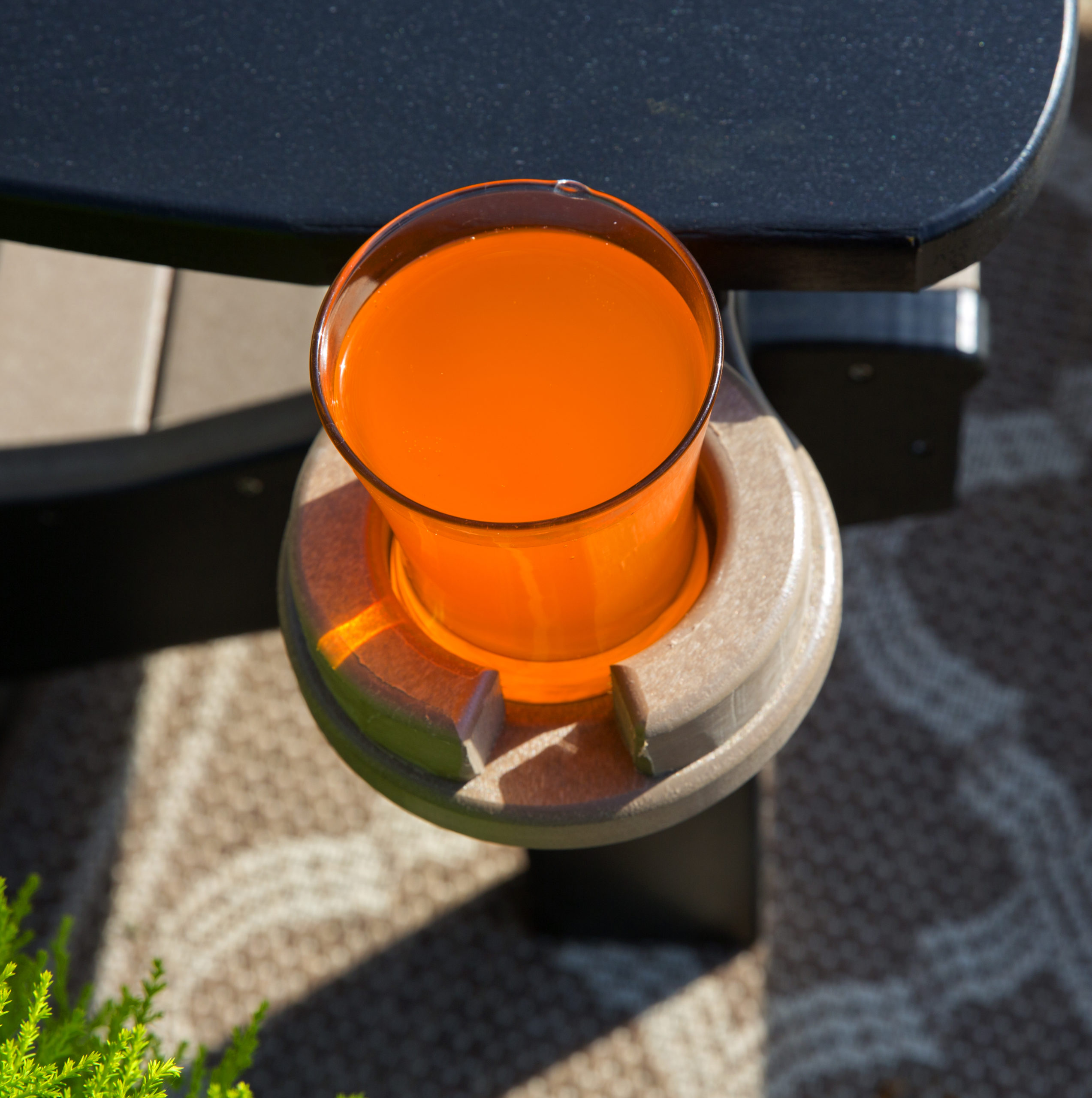 Weathered poly wood and black cupholder.