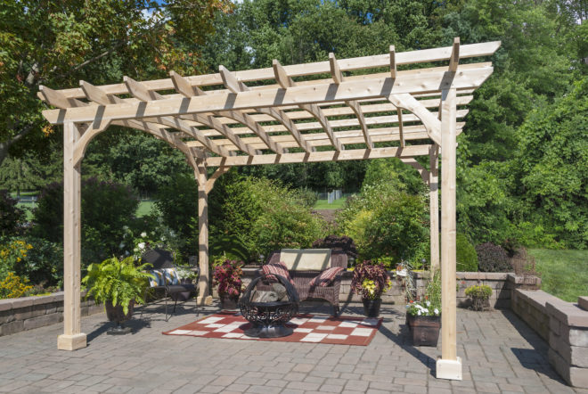 A wooden pergola shading a sitting area.