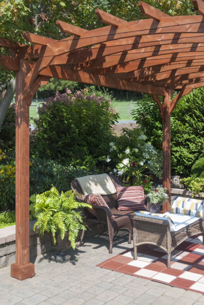 A wooden pergola shading a sitting area.