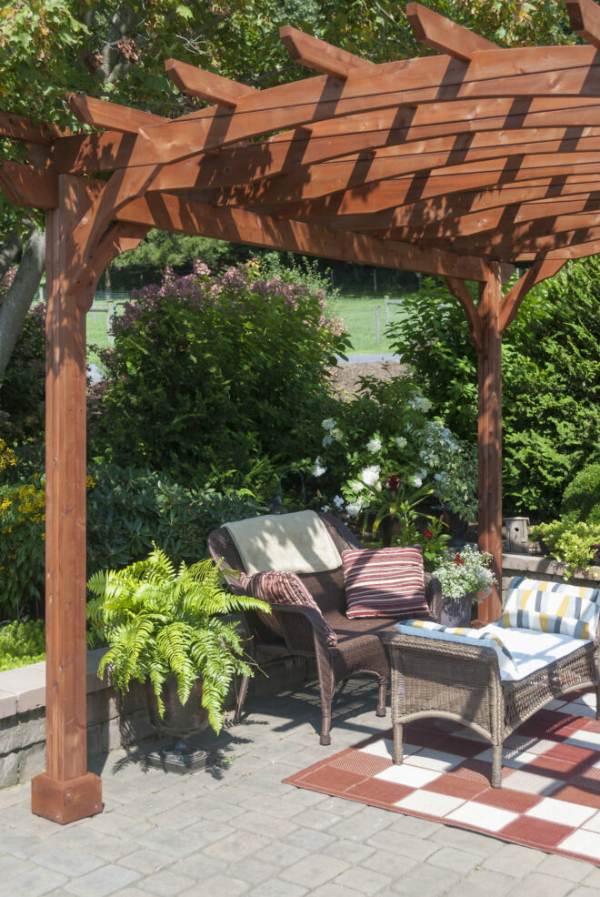A wooden pergola shading a sitting area.