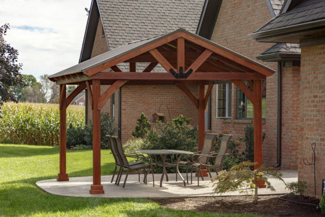 An a frame pavilion sheltering an outdoor seating area.