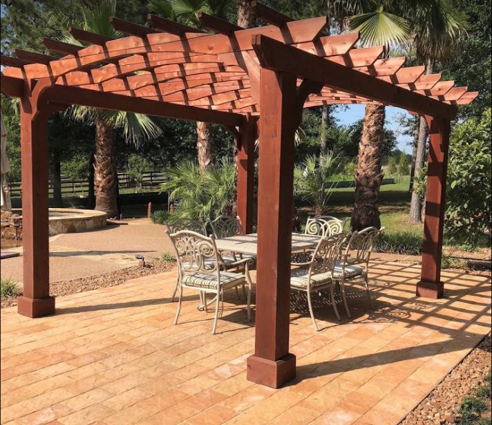 Traditional pergola over an outdoor dining area.