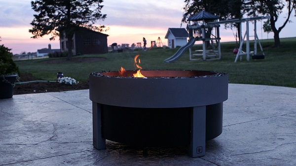 Forge smokeless firepit at night.